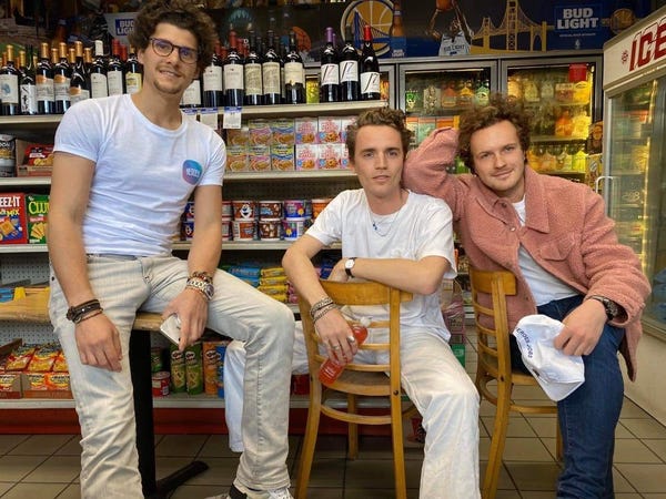 3 casually dressed young business owners in their wine shop.
